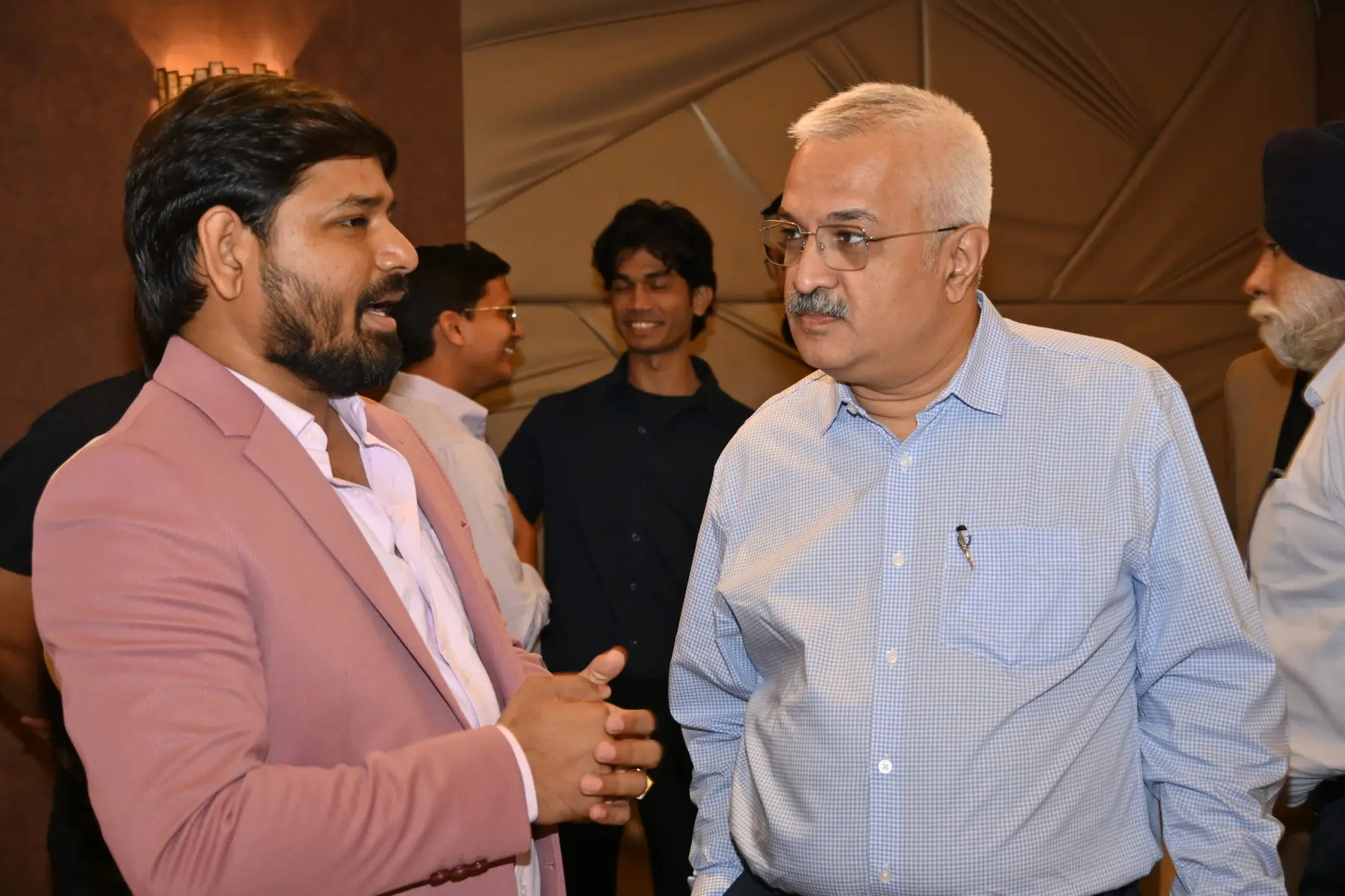 Two members deep in conversation during a Networkers meeting