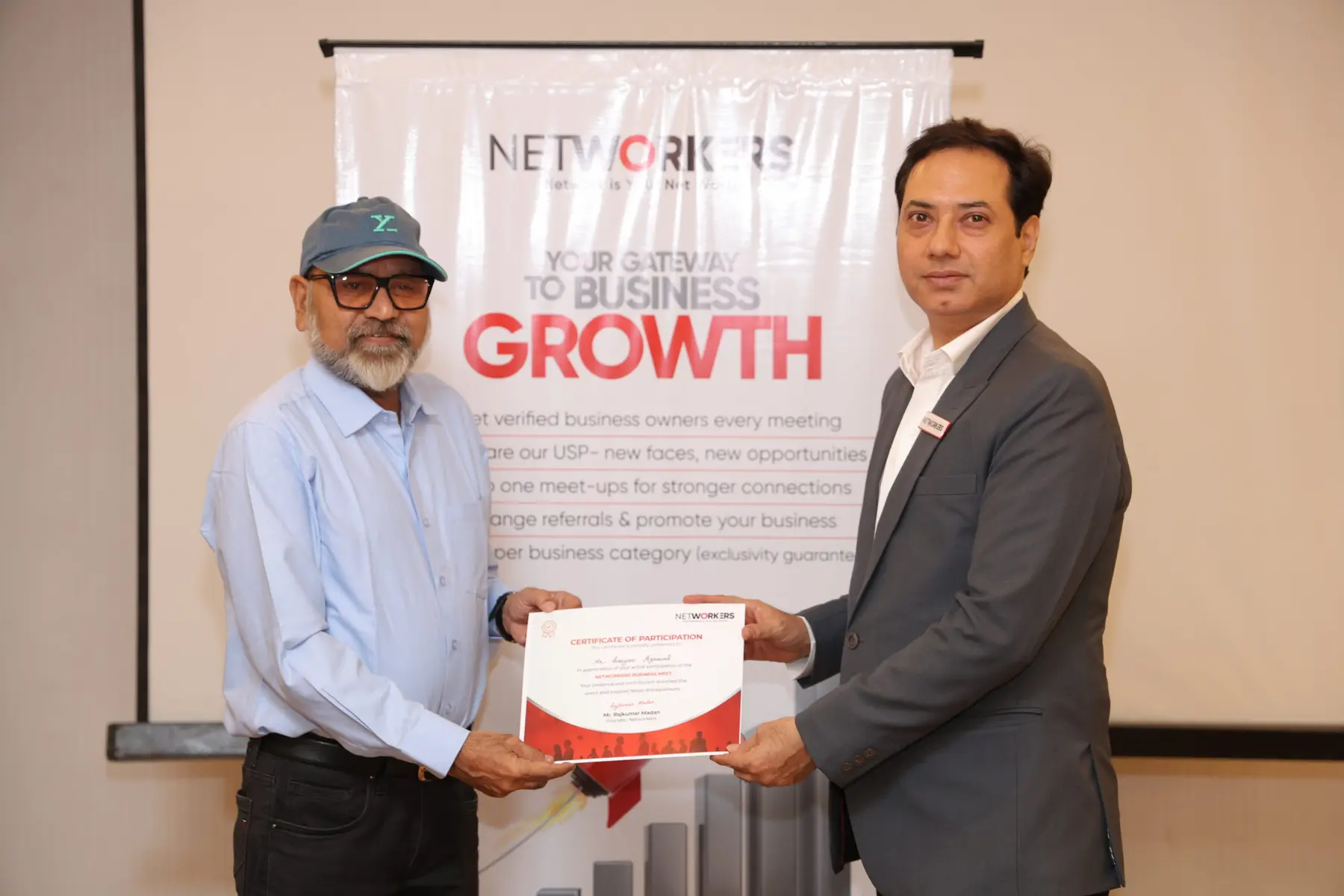 A member receiving a certificate of appreciation at a Networkers meeting