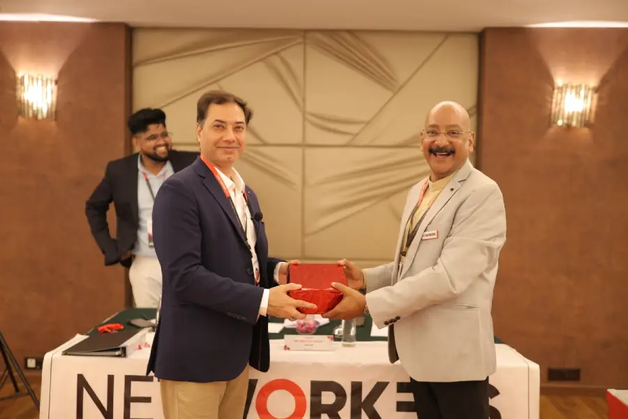 Two members exchanging a gift at a meeting