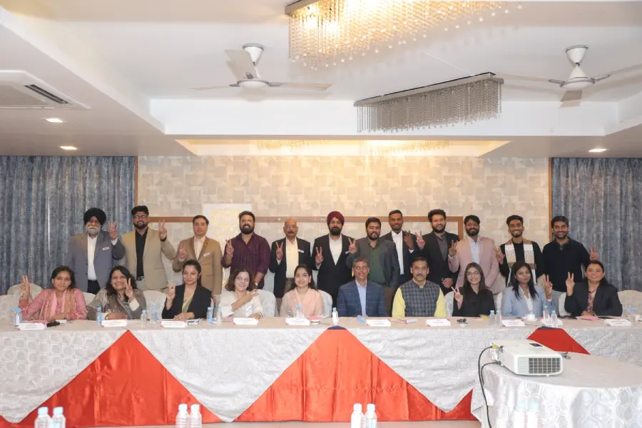 A Networkers chapter together around a red-draped meeting table