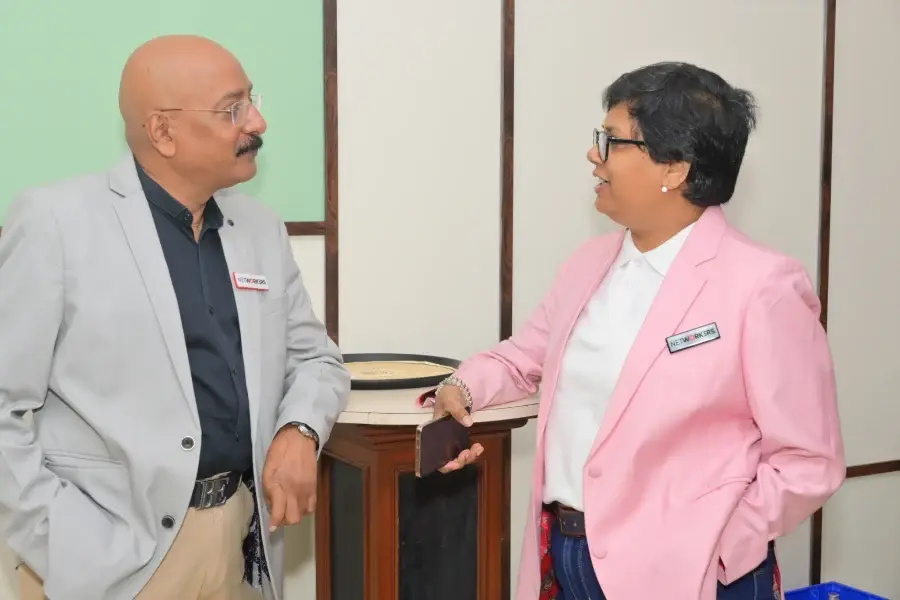 Two members in conversation between sessions